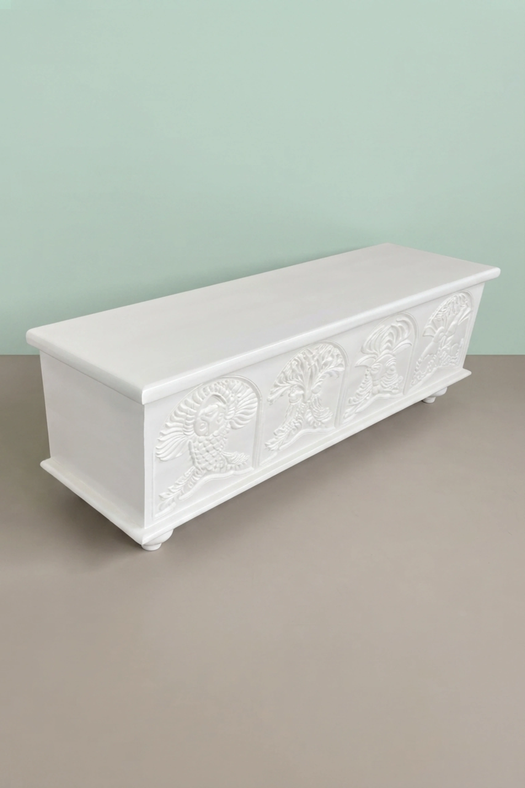 Handcarved_Menagerie_Trunk_White_image_05_lifestyle_room_scene_luxury_handcarved_storage_trunk_chest_white_decorative_bedroom_living_room_artisan_premium_furniture.webp