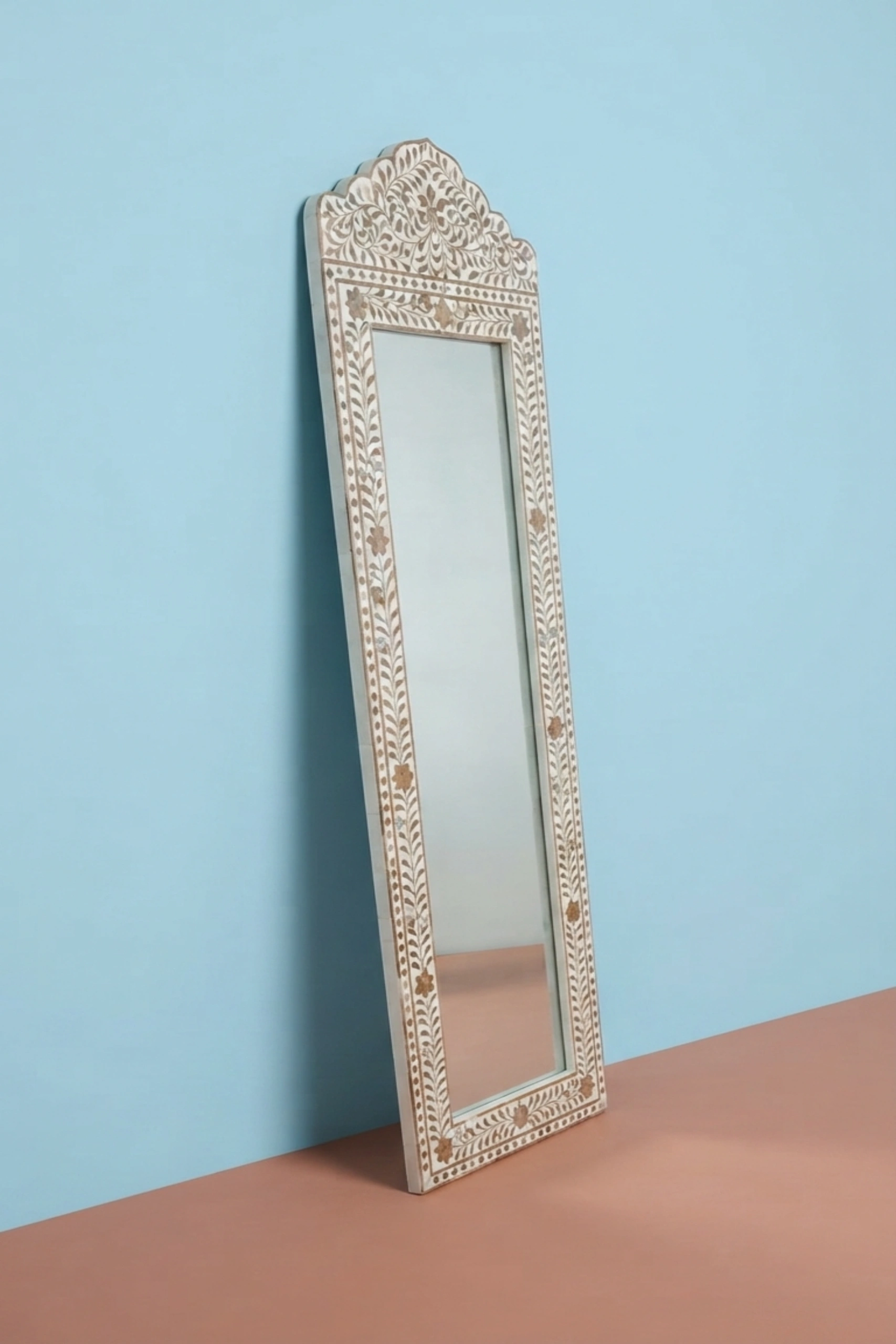 Teakwood_Inlay_Crested_Floor_Mirror_Beige_image_02_angled_view_luxury_decorative_mirror_wall_mirror_floor_mirror_teakwood_brass_statement_home_decor_premium_interior_accent.webp