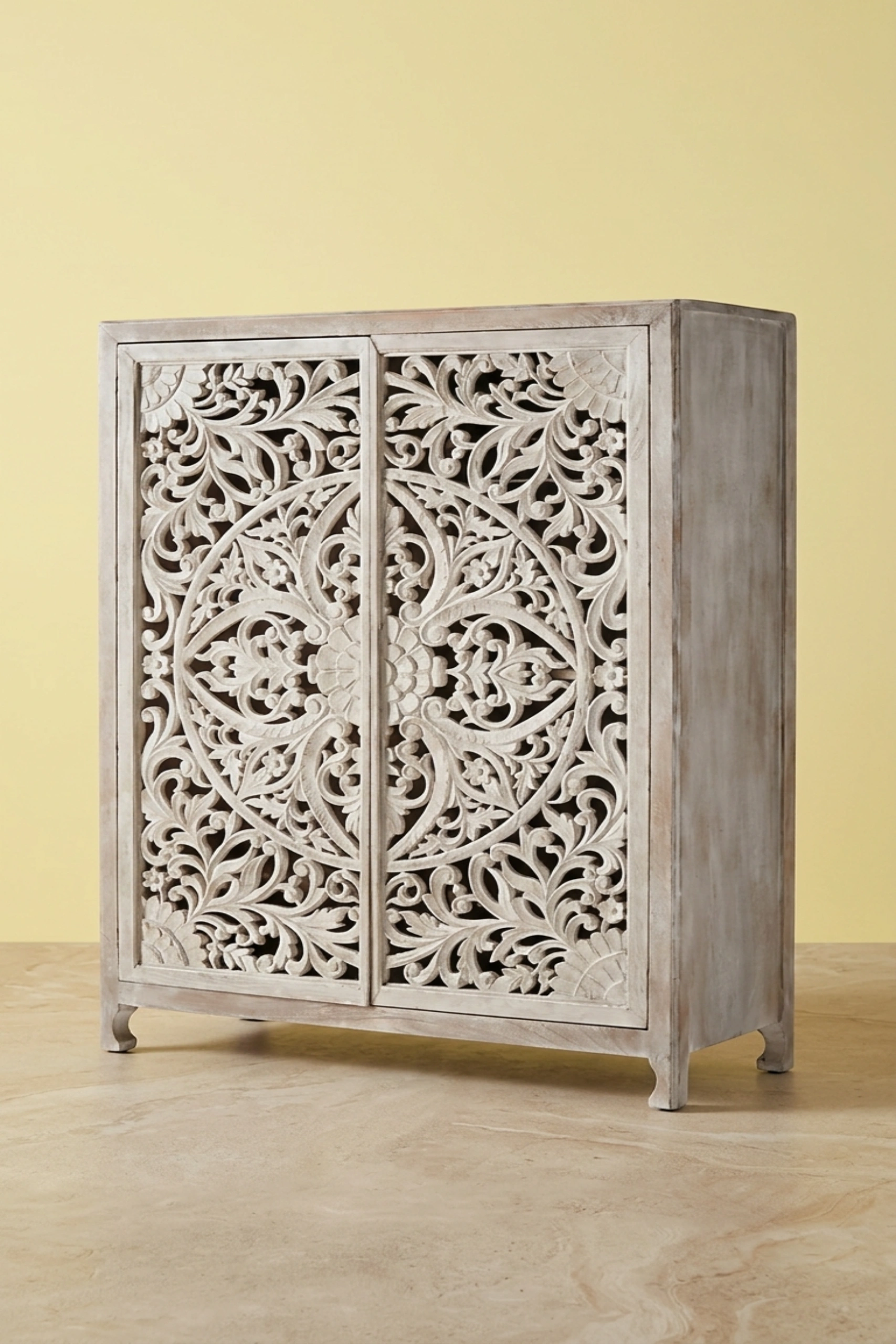 Lombok_Handcarved_2_Door_Wardrobe_White_Wash_image_02_angled_view_luxury_storage_wardrobe_armoire_cupboard_handcrafted_bedroom_living_room_artisan_premium_interior_furniture.webp